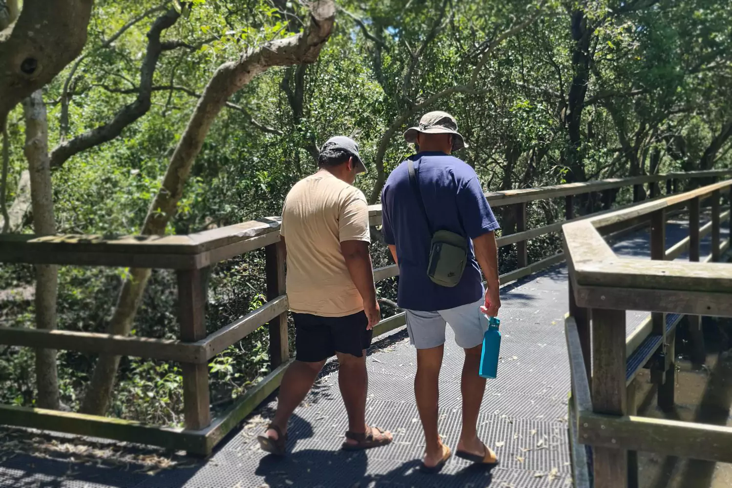 A young participant is on a walk in the forest with his care provider