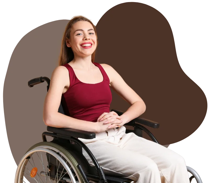A young woman in a wheelchair is smiling at the camera